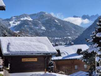 Experience the charm of a winter wonderland with this stunning property nestled amidst snow-capped mountains.
