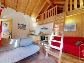 Discover this charming studio apartment featuring a cozy living area with a comfortable sofa and a compact kitchenette, perfect for preparing meals.