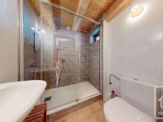 Experience modern comfort in this beautifully appointed bathroom, featuring a spacious glass-enclosed shower with elegant brick-style tiling.