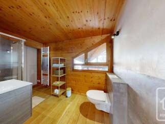 Experience rustic charm in this bathroom featuring a spacious walk-in shower and a modern vanity.