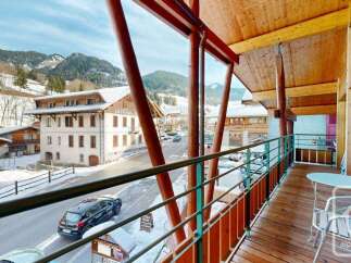 Experience the charm of a mountain village from this charming balcony, offering stunning views of snow-capped peaks and traditional alpine architecture.