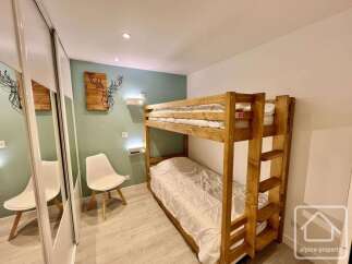 This charming bedroom features a space-saving bunk bed, perfect for families or groups.