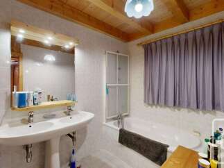 This charming bathroom features a spacious pedestal sink with dual faucets, perfect for busy mornings.