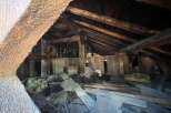 Explore the potential of this unique attic space, featuring rustic wooden beams and ample room for creative renovation.