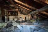Explore the potential of this unique attic space, featuring rustic exposed wooden beams and ample room for creative renovation.