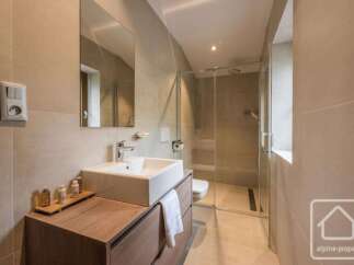 Experience modern comfort in this beautifully appointed bathroom, featuring a sleek vanity with a vessel sink and a spacious walk-in shower with glass enclosure.