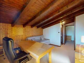 Discover this charming room featuring a cozy sofa bed and a functional desk area, perfect for relaxation or work.