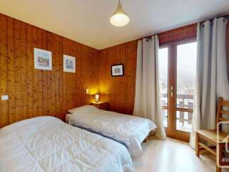 This charming bedroom features two comfortable twin beds, perfect for guests or family.