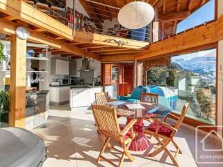 Experience breathtaking mountain views from this stunning property, featuring a modern kitchen and a cozy dining area perfect for family gatherings.