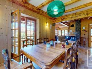 Experience rustic charm in this inviting dining room, featuring a large wooden table perfect for family gatherings.
