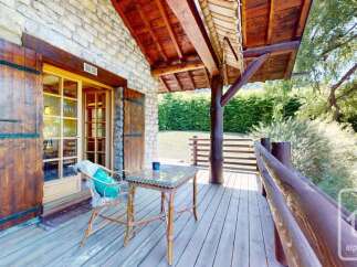 Enjoy the serene mountain views from this charming wooden deck, perfect for morning coffee or evening relaxation.