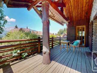 Enjoy the stunning mountain views from this charming wooden balcony, perfect for relaxing with a morning coffee or evening drink.