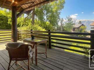 Enjoy breathtaking mountain views from this charming wooden balcony, perfect for your morning coffee or evening relaxation.