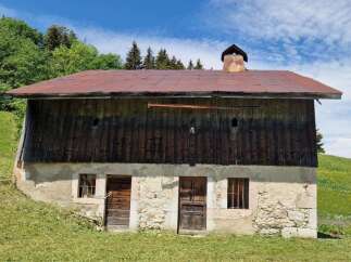 Discover this charming rustic property nestled in a serene alpine setting, perfect for those seeking a tranquil escape.