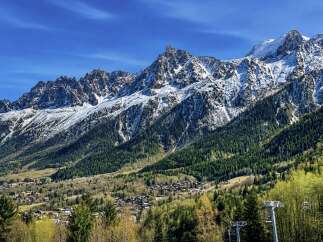 Experience breathtaking mountain views from this stunning property, nestled amidst lush green forests and snow-capped peaks.
