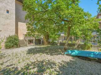 Discover this charming property featuring a spacious backyard with mature trees, perfect for outdoor relaxation and activities.
