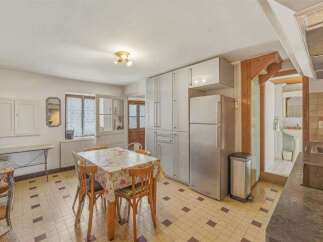 This charming kitchen and dining area offers a functional layout with ample storage.