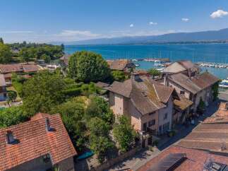 Discover this charming property nestled in a picturesque lakeside town, offering stunning views of the water and distant mountains.
