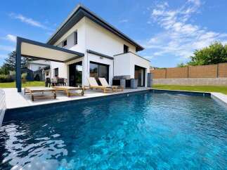 Experience luxury living in this modern home featuring a stunning private pool perfect for relaxation and entertainment.