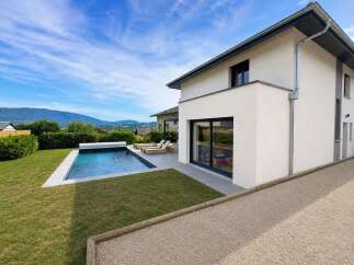 Experience modern living in this stunning property featuring a pristine swimming pool and lush green lawn, perfect for relaxation and entertainment.
