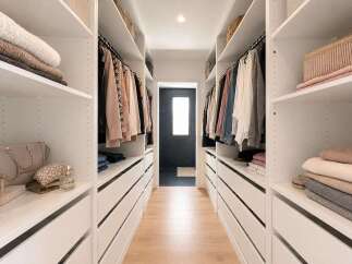 Step into this impeccably organized walk-in closet, designed for the discerning homeowner.