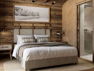 Experience rustic luxury in this charming bedroom, featuring a cozy bed adorned with plaid accents and a warm, wood-paneled ambiance.