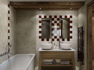 Experience rustic luxury in this stunning bathroom, featuring a freestanding bathtub and a double vanity with vessel sinks.