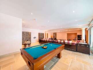 Experience ultimate relaxation and entertainment in this spacious living area, featuring a professional billiard table perfect for friendly games.