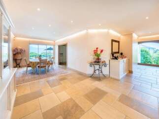 Step into this elegant home featuring a spacious dining area with a large window offering scenic views.