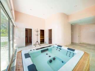 Indulge in ultimate relaxation with this luxurious spa area, featuring a spacious hot tub perfect for unwinding.