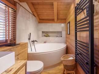 Experience ultimate relaxation in this luxurious bathroom, featuring a spacious corner bathtub perfect for unwinding.