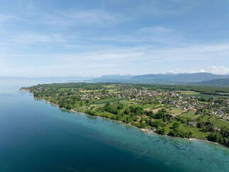 Experience serene lakeside living with this stunning aerial view of properties nestled along the tranquil waters.