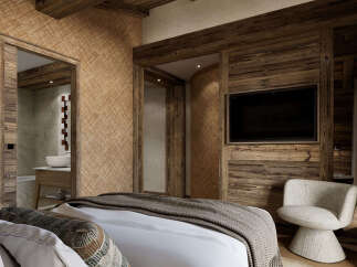 Experience rustic luxury in this beautifully appointed bedroom, featuring warm wood accents and textured walls for a cozy alpine ambiance.