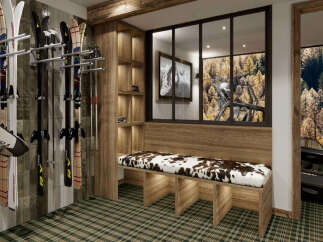 Experience the ultimate ski retreat with this beautifully designed ski room, featuring ample storage for skis and poles, and a cozy bench with a unique cowhide-patterned cushion.
