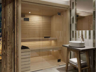 Experience ultimate relaxation in this luxurious spa area, featuring a modern glass-enclosed sauna with natural wood interiors.