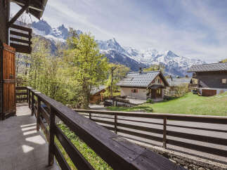 Experience breathtaking mountain views from this charming chalet, nestled amidst lush greenery.