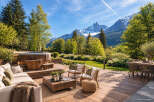 Experience ultimate relaxation in this stunning outdoor living space, featuring a luxurious wooden hot tub with breathtaking mountain views.