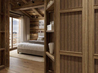 Experience rustic luxury in this charming bedroom, featuring exposed wooden beams and a cozy fireplace.