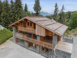 Experience luxury mountain living in this stunning chalet, featuring a harmonious blend of natural stone and warm timber construction.