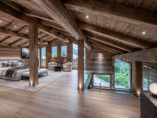 Experience luxurious mountain living in this stunning chalet bedroom, featuring exposed wooden beams and a vaulted ceiling that creates an airy, open atmosphere.