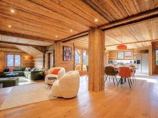 Experience rustic luxury in this stunning wooden chalet, featuring a spacious open-plan living and dining area perfect for gatherings.