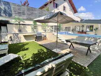 Enjoy outdoor living at its finest with this stunning backyard oasis, featuring a sparkling swimming pool perfect for hot summer days.