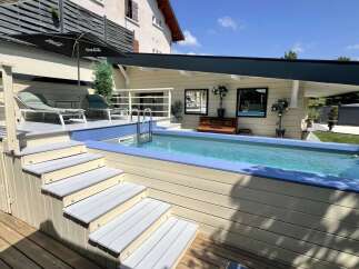 Escape to your private oasis with this stunning backyard featuring a refreshing swimming pool and a spacious wooden deck.