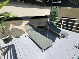 Relax and unwind on this private deck featuring two comfortable lounge chairs perfect for soaking up the sun.