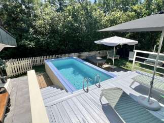 Escape to your private oasis with this stunning backyard featuring a refreshing rectangular pool, perfect for a dip on a sunny day.