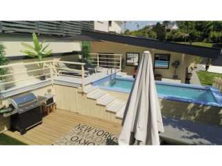 Experience ultimate relaxation in this modern backyard oasis, featuring a sleek swimming pool and a spacious wooden deck perfect for entertaining.