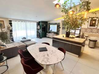 Experience modern living in this spacious open-plan apartment, featuring a comfortable sectional sofa and a stylish marble-top dining table perfect for entertaining.