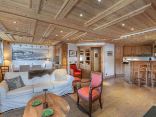 Experience luxurious alpine living in this stunning wooden chalet featuring a spacious open-plan living area.