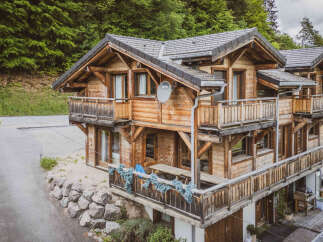 Experience the charm of this rustic wooden chalet nestled amidst lush green forests.