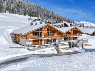Experience luxury mountain living in this stunning chalet, nestled amidst a winter wonderland.